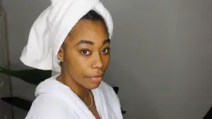 beautiful black woman using vitamin c on the skin